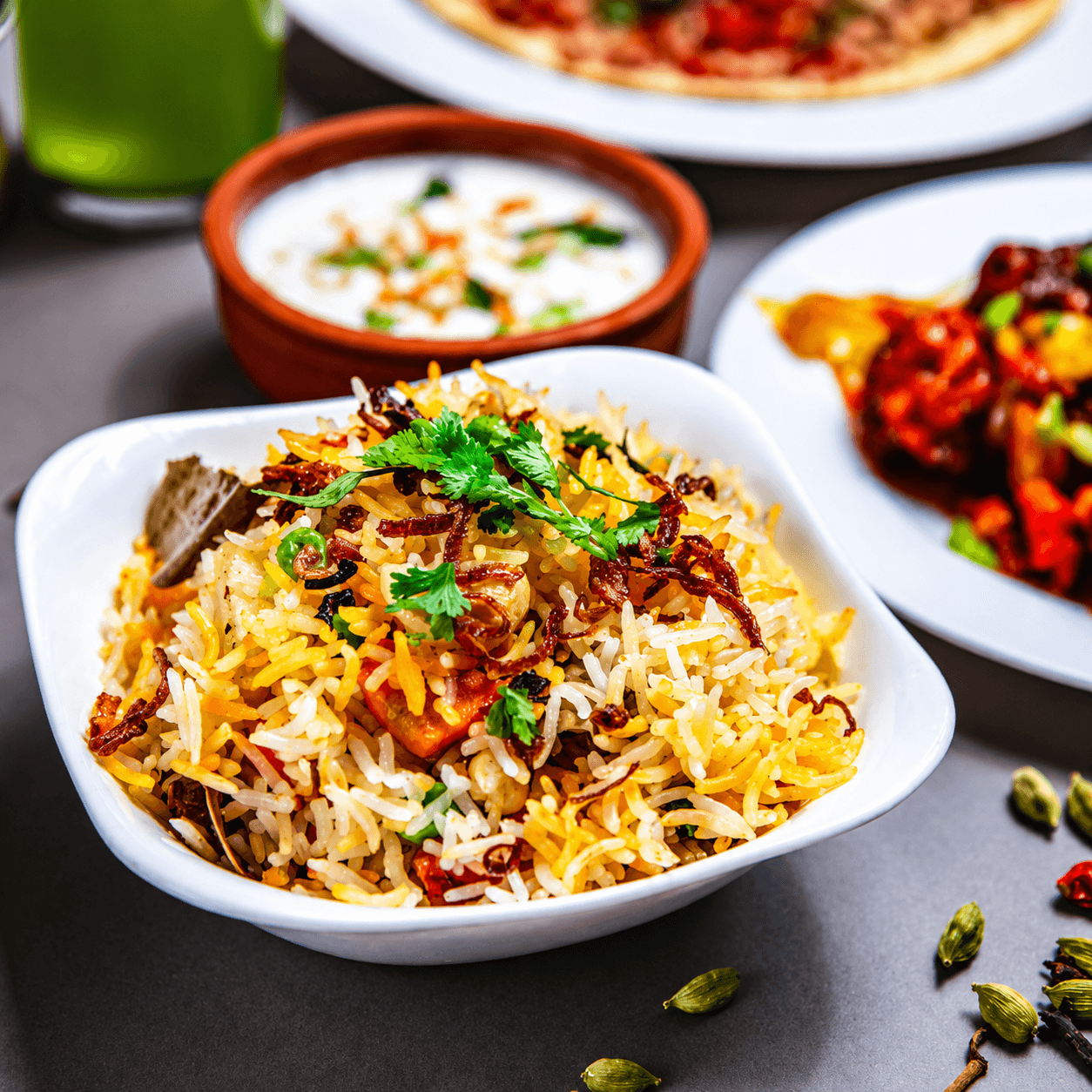 Biryani bowl garnished with fried onions and cilantro